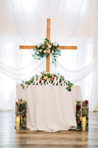 A cross overlooks the sweetheart table and reception hall in Indiana.
